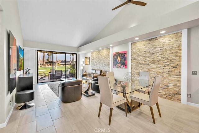 dining space featuring high vaulted ceiling and ceiling fan