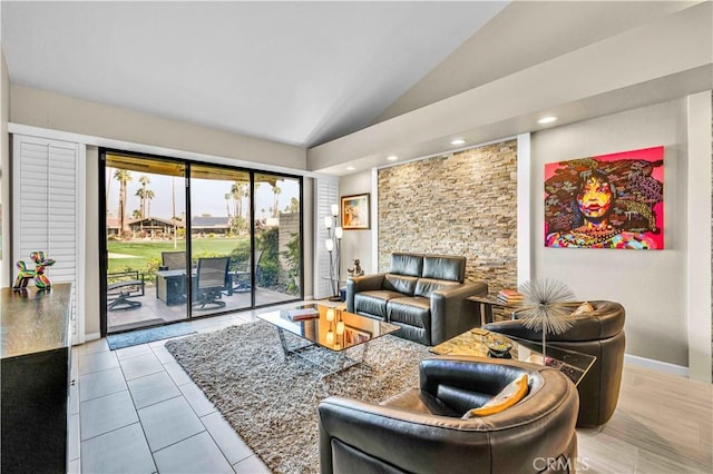 living room featuring light tile patterned flooring and vaulted ceiling