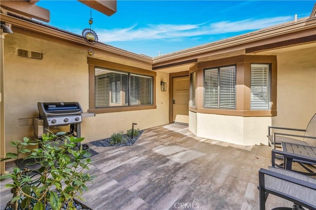 doorway to property with a patio area