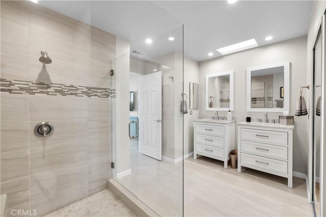 bathroom with vanity, a skylight, and walk in shower