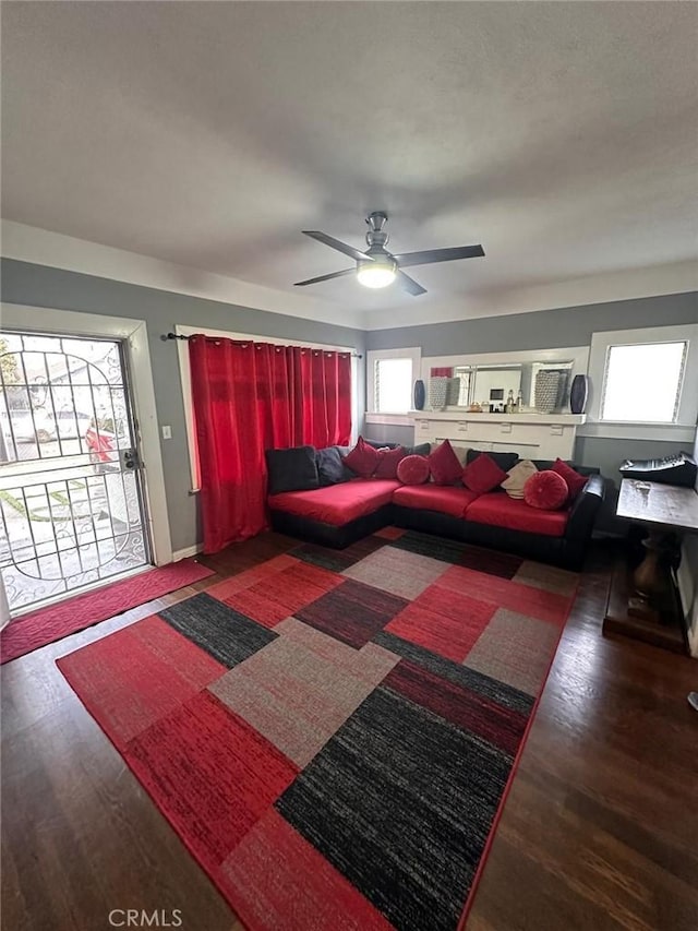 living area with wood finished floors and a healthy amount of sunlight