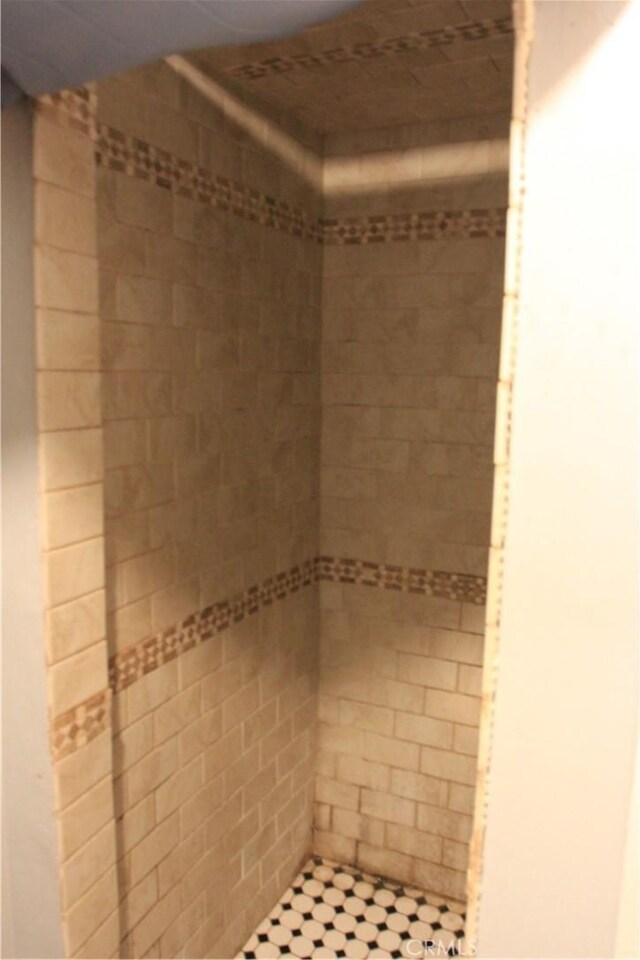 bathroom with tiled shower