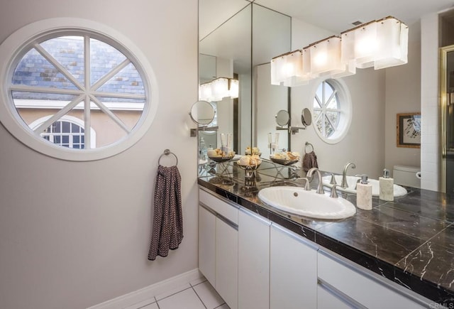 bathroom featuring tile patterned flooring, vanity, and toilet