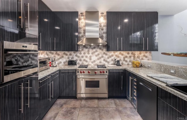 kitchen with light stone countertops, decorative backsplash, stainless steel appliances, and wall chimney exhaust hood