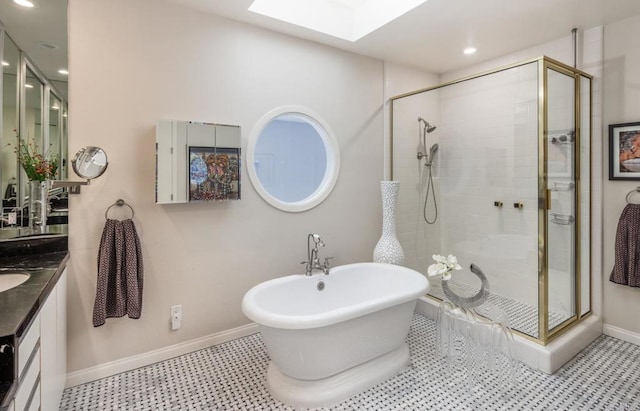 bathroom with vanity, plus walk in shower, and a skylight