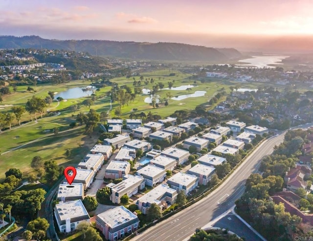 aerial view at dusk with a water and mountain view