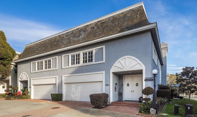 7487 Via De Fortuna, Carlsbad, CA 92009 - view of front of house featuring stucco siding, decorative driveway, a garage, and roof with shingles