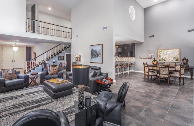 7487 Via De Fortuna, Carlsbad, CA 92009 - living room with a high ceiling, stairway, baseboards, and recessed lighting