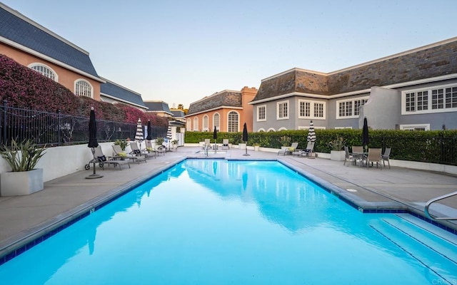 7487 Via De Fortuna, Carlsbad, CA 92009 - pool at dusk with a patio area and a community pool