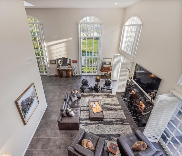 7487 Via De Fortuna, Carlsbad, CA 92009 - living area with a high end fireplace, tile patterned flooring, and baseboards