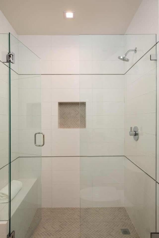 bathroom featuring a shower with shower door