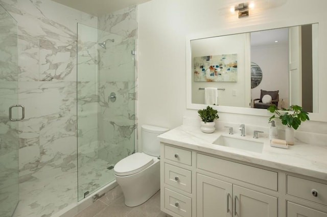 bathroom featuring vanity, a shower with shower door, and toilet