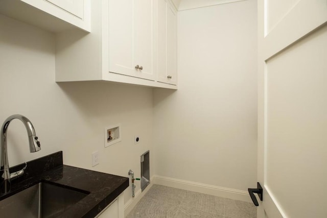 clothes washing area featuring gas dryer hookup, sink, electric dryer hookup, hookup for a washing machine, and cabinets