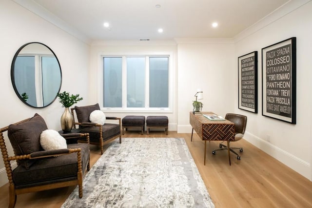 sitting room featuring hardwood / wood-style floors and crown molding