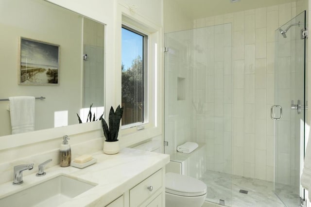 bathroom featuring vanity, walk in shower, and toilet