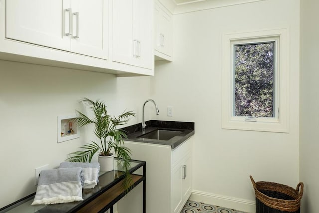 clothes washing area with washer hookup, sink, and cabinets