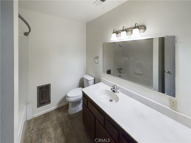 full bathroom featuring vanity, hardwood / wood-style floors, shower / bathing tub combination, and toilet