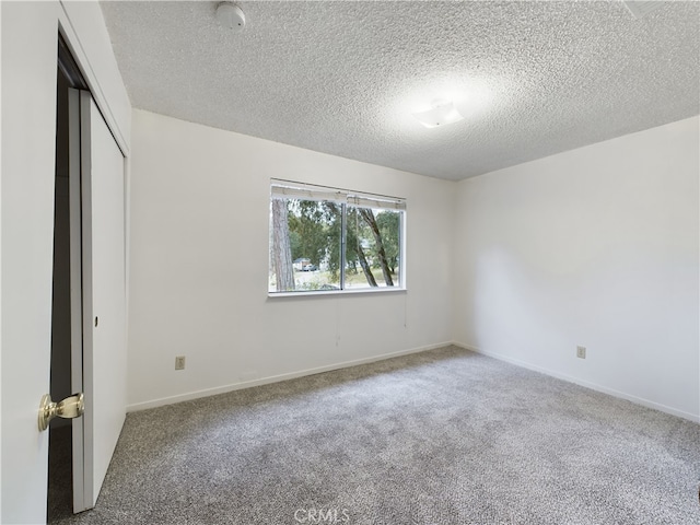 unfurnished bedroom featuring carpet floors, a closet, and a textured ceiling