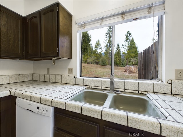 kitchen with dishwasher, sink, tile countertops, and dark brown cabinetry