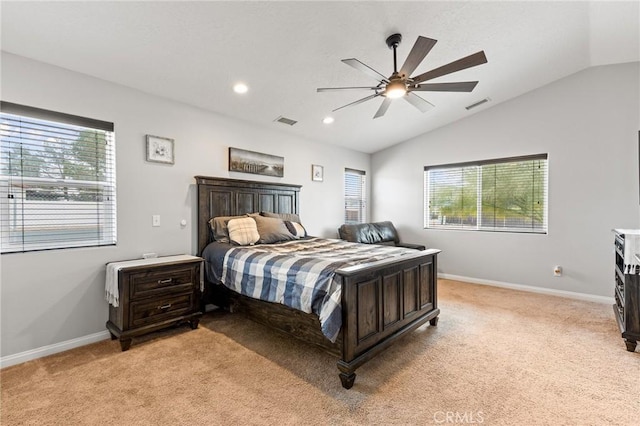 carpeted bedroom featuring lofted ceiling, multiple windows, and ceiling fan