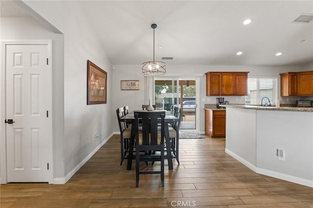 dining room featuring dark hardwood / wood-style flooring, sink, and a wealth of natural light