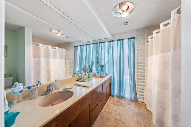 bathroom with vanity and a textured ceiling