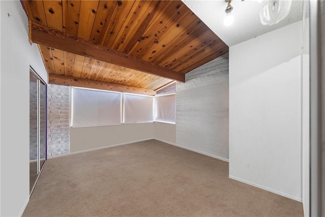 spare room featuring wood ceiling, carpet floors, and lofted ceiling with beams