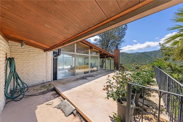 view of patio / terrace featuring a mountain view