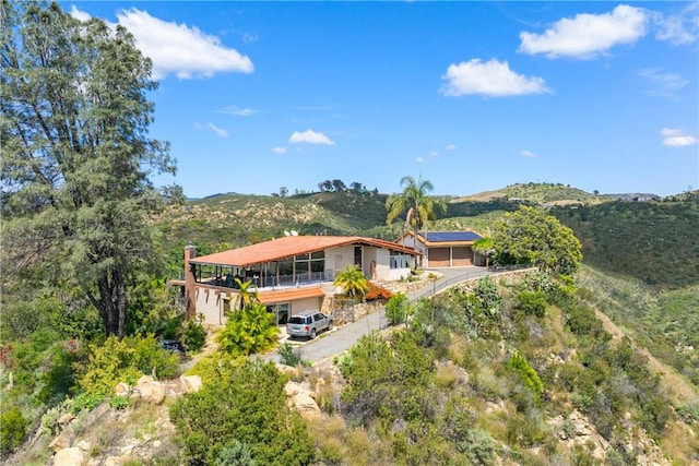 rear view of property featuring a mountain view