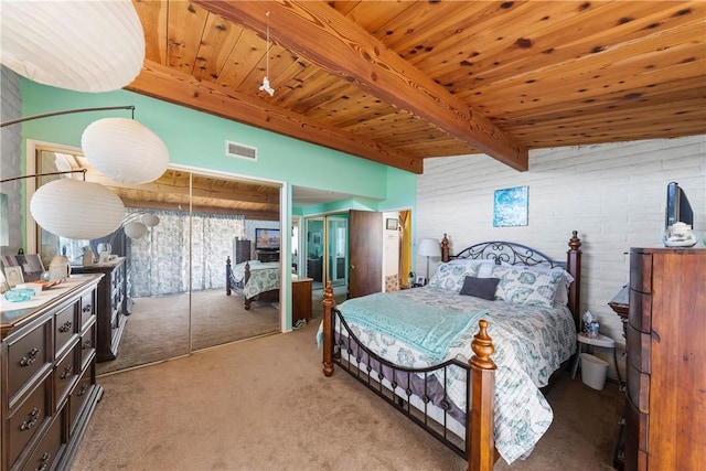 carpeted bedroom featuring multiple closets, wood ceiling, and beamed ceiling