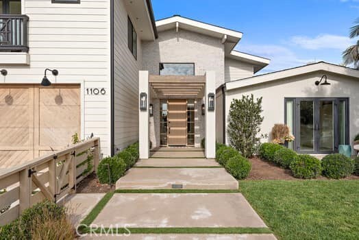 entrance to property featuring a lawn