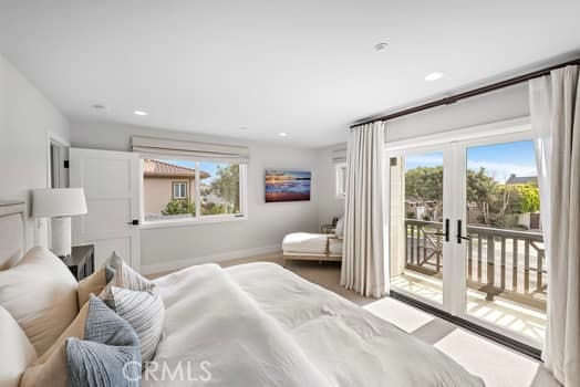 bedroom with french doors, multiple windows, and access to outside