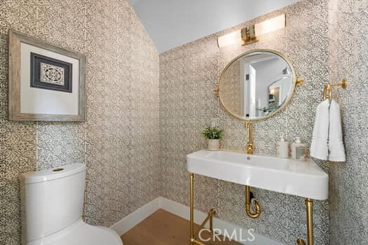 bathroom with vaulted ceiling and toilet