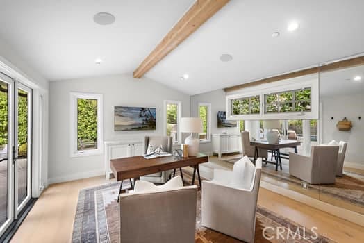 living room with vaulted ceiling with beams and light hardwood / wood-style flooring