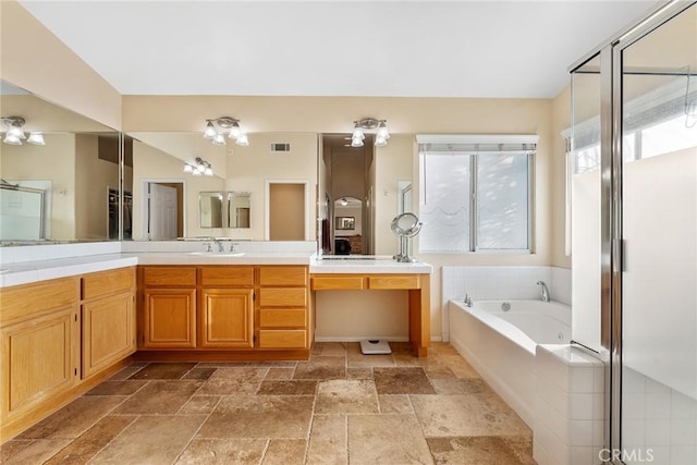 bathroom with vanity and separate shower and tub