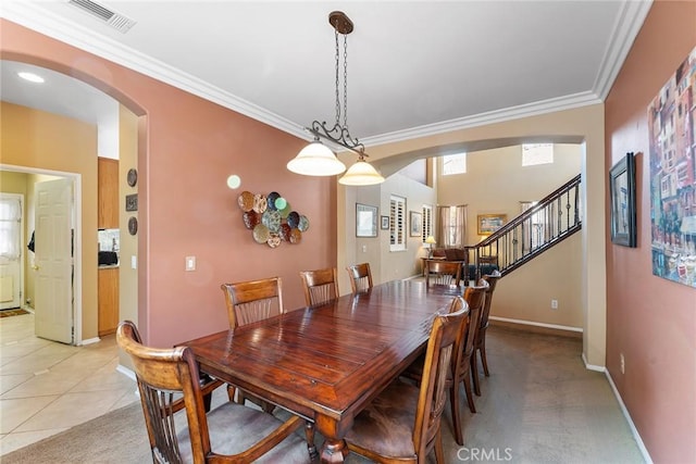 dining area with light colored carpet and ornamental molding