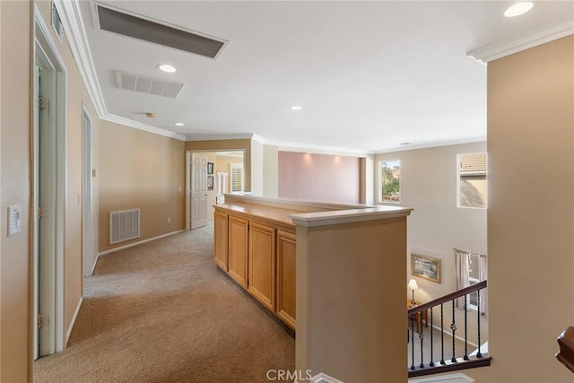 hall with light colored carpet and ornamental molding