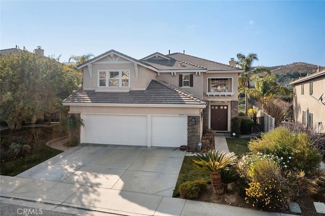 front facade with a garage and a mountain view