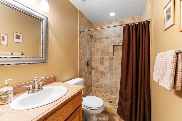 bathroom featuring vanity, a shower with curtain, and toilet