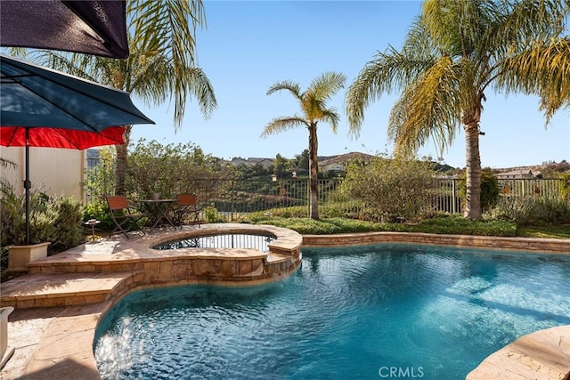 view of pool with an in ground hot tub