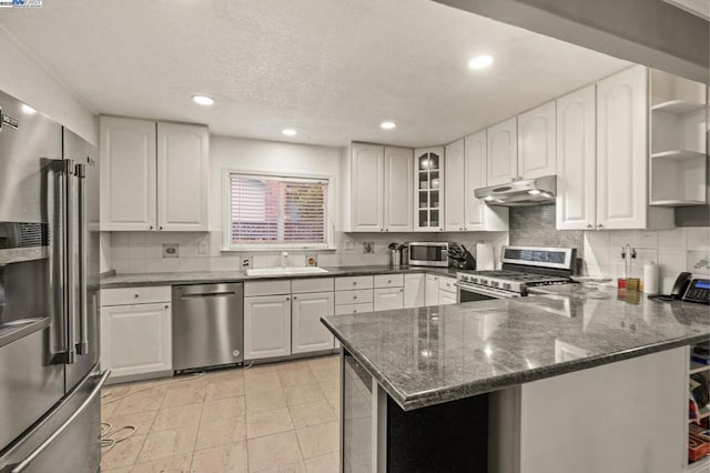 kitchen featuring white cabinetry, sink, kitchen peninsula, and appliances with stainless steel finishes