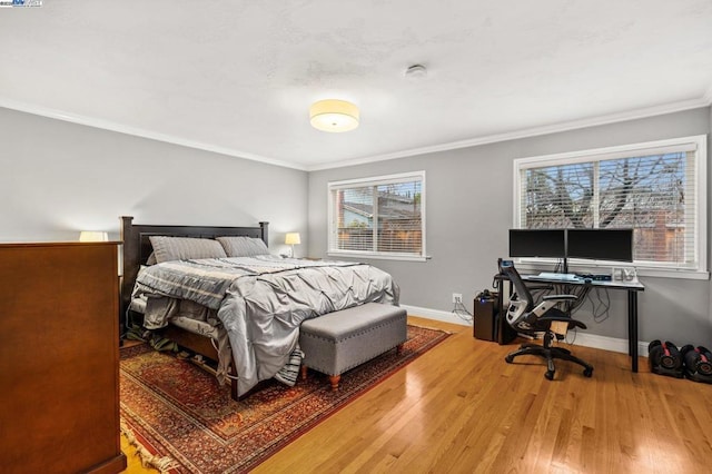 bedroom featuring hardwood / wood-style flooring and crown molding