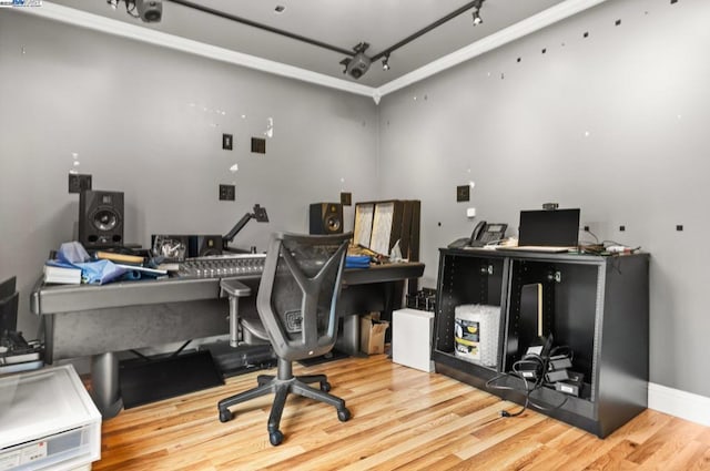 office space with hardwood / wood-style flooring and track lighting