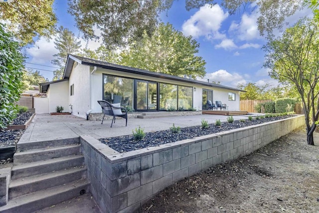 rear view of property with a patio and a wooden deck