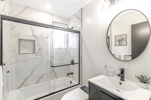 full bathroom featuring vanity, toilet, and combined bath / shower with glass door