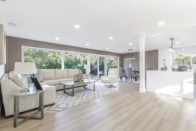 living room featuring an inviting chandelier and light hardwood / wood-style floors