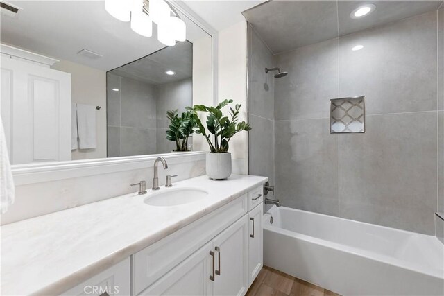 6054 N Woodson Ave, Fresno, CA 93711 - full bathroom featuring visible vents, vanity, and washtub / shower combination