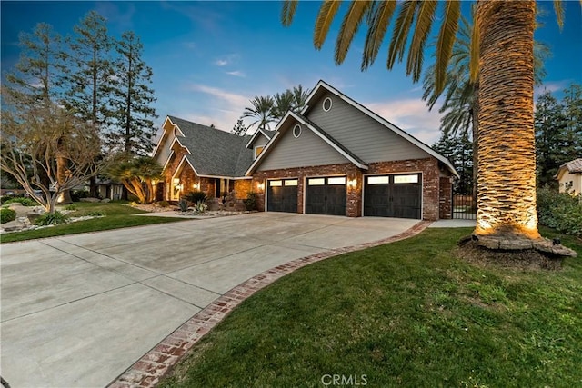 6054 N Woodson Ave, Fresno, CA 93711 - view of front facade with concrete driveway, an attached garage, a lawn, and brick siding