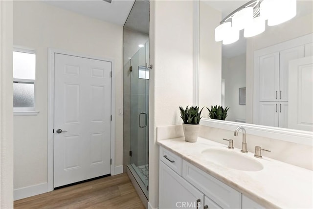 6054 N Woodson Ave, Fresno, CA 93711 - bathroom with a shower stall, vanity, baseboards, and wood finished floors