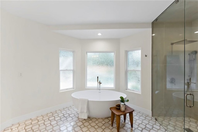 6054 N Woodson Ave, Fresno, CA 93711 - full bathroom featuring a shower stall, a freestanding tub, and baseboards
